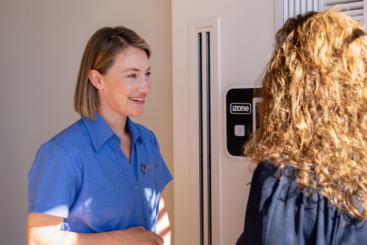 lady demonstrating how to use izone smart ac