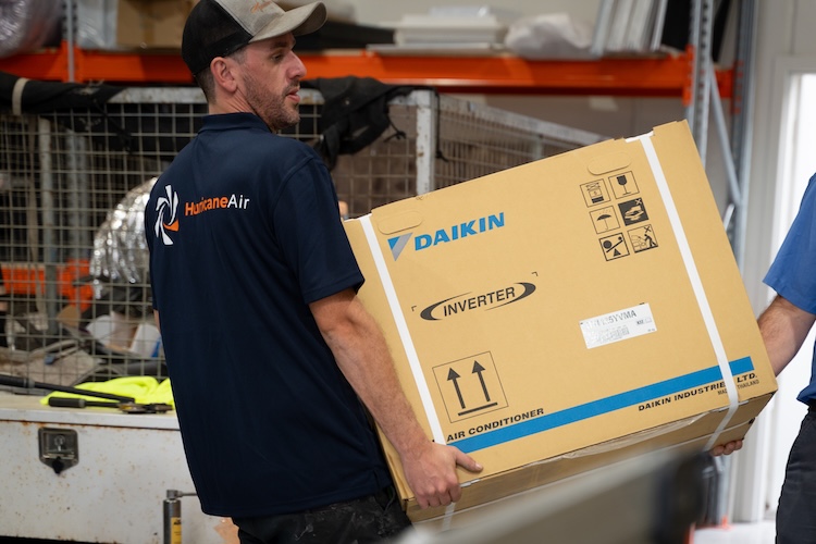 hurricane air technicians carrying daikin aircon