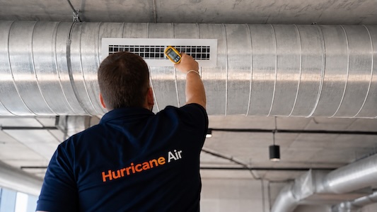 air con technician checking temperature